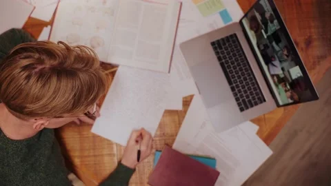 Young man studying at home, having a video call on a laptop, writing notes Vídeo Stock 164380743