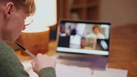 Young man studying at home, having a video call on a laptop, writing his notes Vídeo Stock 164381476
