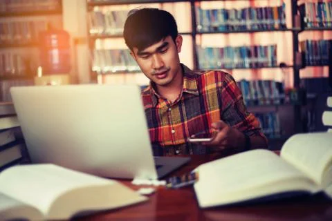 The young man is studying for knowledge in the library 스톡 사진