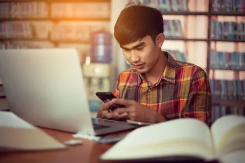 The young man is studying for knowledge in the library Stock Photos
