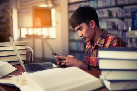 The young man is studying for knowledge in the library Stock Photos