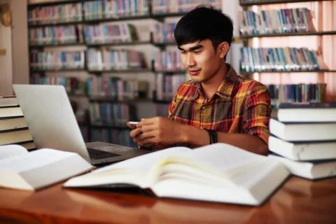 The young man is studying for knowledge in the library Stock Photos
