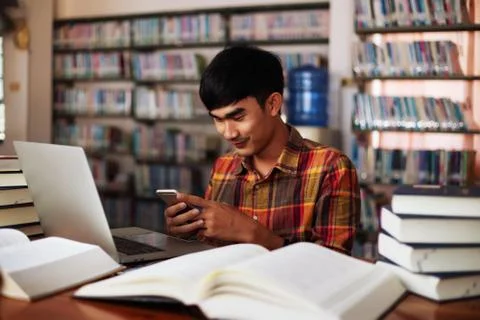 The young man is studying for knowledge in the library Stock Photos