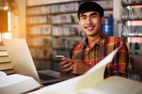 The young man is studying for knowledge in the library Stock Photos