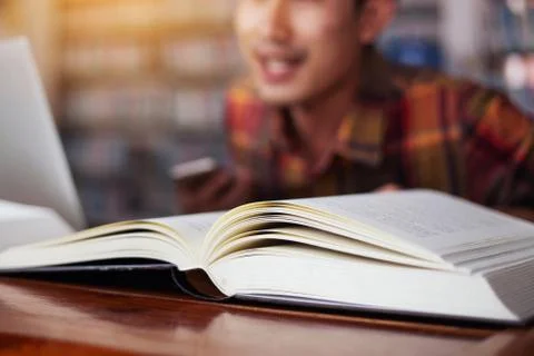 The young man is studying for knowledge in the library Stock Photos