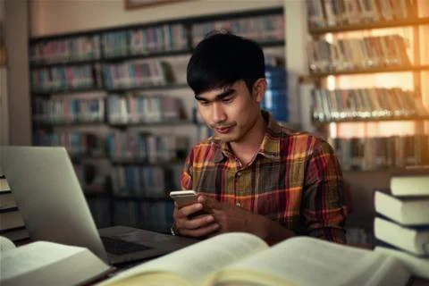The young man is studying for knowledge in the library Stock Photos
