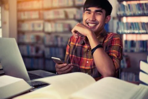 The young man is studying for knowledge in the library Stock Photos