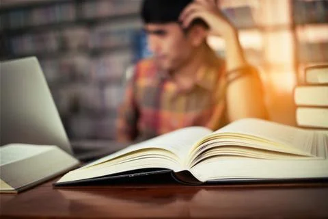 The young man is studying for knowledge in the library Stock Photos
