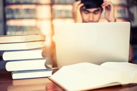 The young man is studying for knowledge in the library Stock Photos