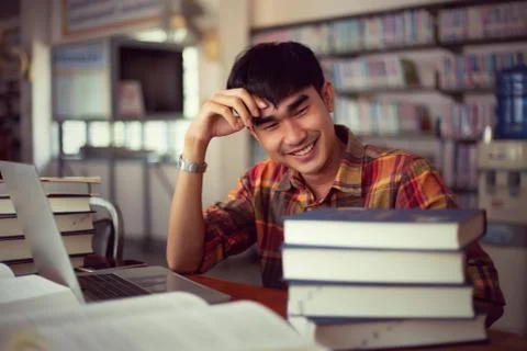 The young man is studying for knowledge in the library Stock Photos