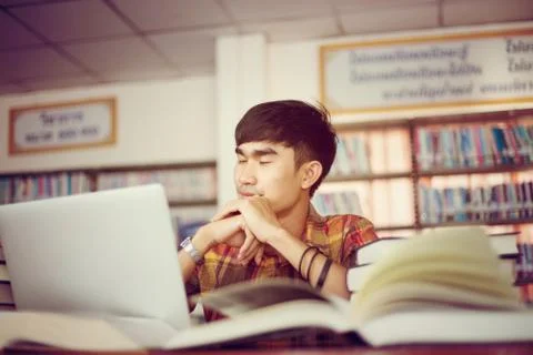 The young man is studying for knowledge in the library Stock Photos