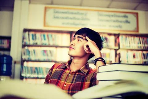 The young man is studying for knowledge in the library Stock Photos