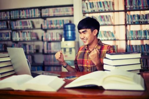 The young man is studying for knowledge in the library Stock Photos