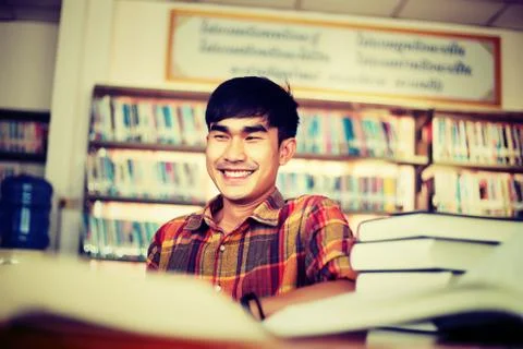 The young man is studying for knowledge in the library Stock Photos