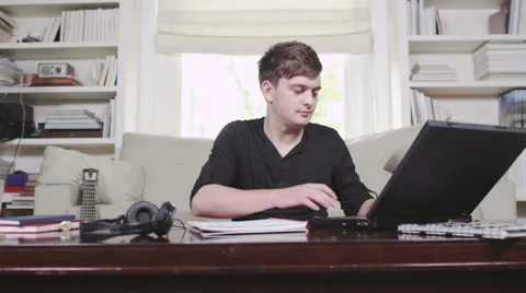 Young man studying with laptop 스톡 동영상 32938990