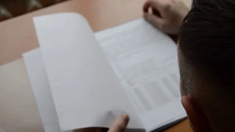 A young man is studying some material Stock Footage 73077164