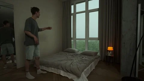 Young man suffering from auditory hallucinations and hearing voices in modern Stock Footage 312627650