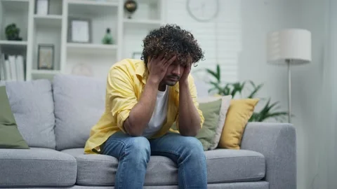 Young man suffering depression mental health problems sitting alone at home  Stock Footage 235488714