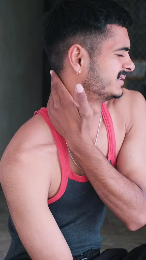 Young man suffering from severe neck and shoulder pain at home Video stock 331062929