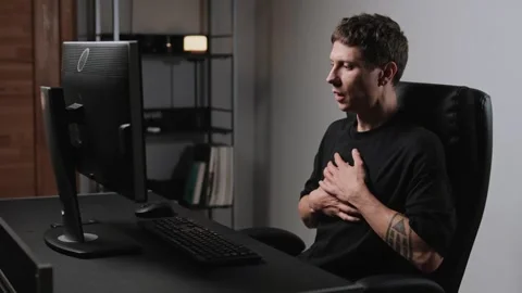Young man suffering sudden panic attack at home office remote work stress Stock Footage 317945881