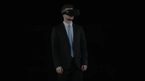Young man in a suit and vr glasses stands surprised Stock Footage 77678166