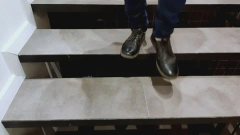 Young man in a suit comes down the stairs Stock Footage 170626771