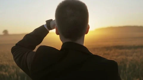 Young man in suit looking ahead at the sun Stock Footage 71926350