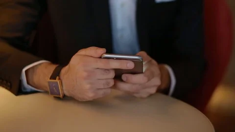 Young man in suit using smartphone Stock Footage 72376652