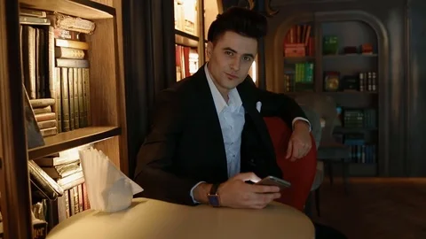 Young man in suit using smartphone Video stock 72376740