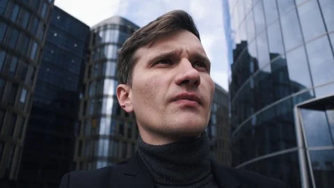 Young man in suit using smartphone. Glass business centre building at background Stock Footage 79416131