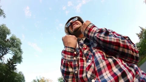 Young man in sunglasses posing at the camera Stock Footage 69789302
