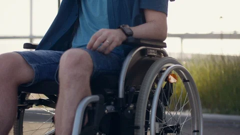 Young man in sunglasses using mobile phone, making pics, physically disabled man Stock Footage 110212599