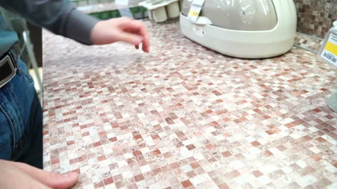 Young man at superstore selecting a new kitchen furniture. Guy examining samples Video stock 88161087