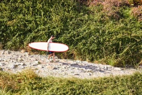 Young man with a surf board Stock Photos