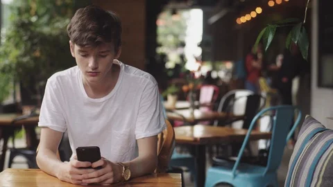 Young Man surfing internet in mobile phone, handy touch and sending text message 動画素材 112386001
