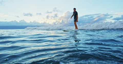 Young Man Surfing Longboard Stock Footage 67767751