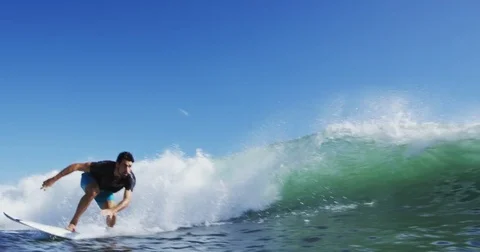 Young Man Surfing Ocean Wave in Slow Motion Stock Footage 76283704