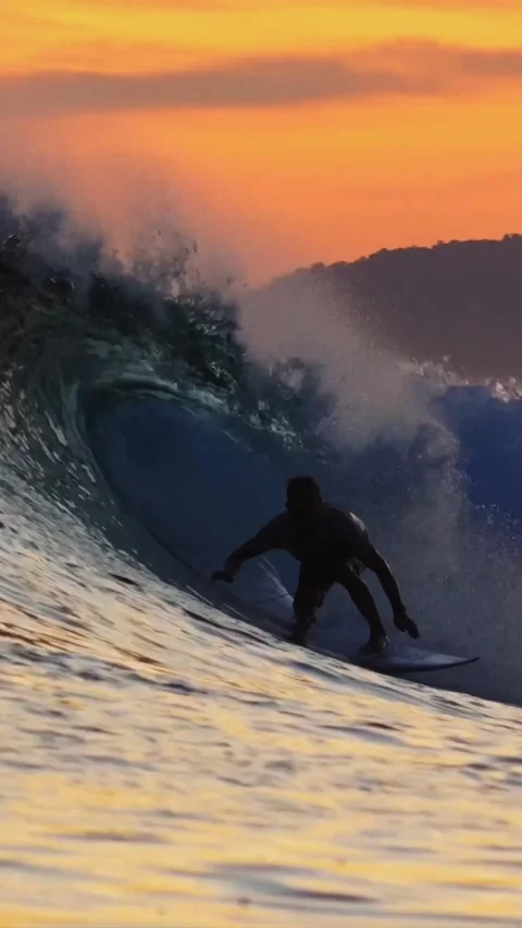 Young man surfing at sunset.Vertical video Stock Footage 295758883