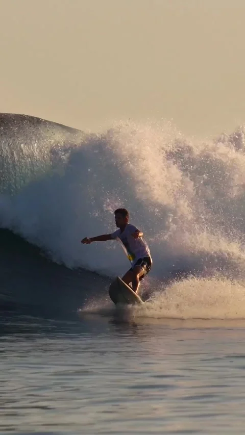 Young man surfing at sunset.Vertical video Stock Footage 295759042