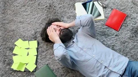 Young man surrounded by computer and documents, very tired and exhausted. Stock Footage 154206001