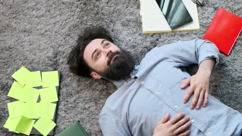Young man surrounded by computer and documents, very tired and exhausted. Stock Footage 155404682