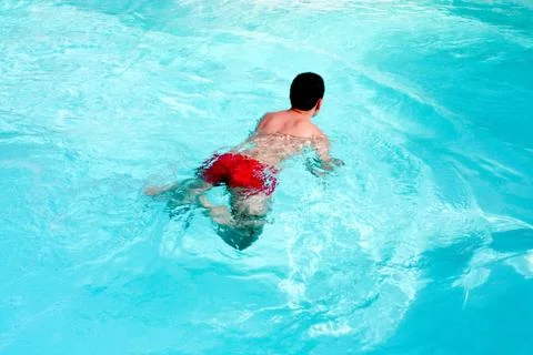 Young man swimming Stock Photos