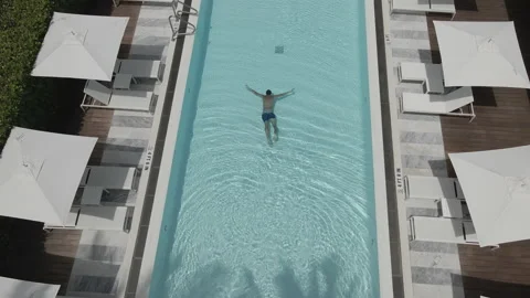 The young man swimming in the pool. Stock Footage 153889097
