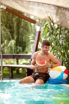 Young man on swimming pool refreshing Stock Photos