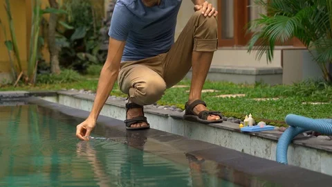 Young man swimming pool serviceman checking chlorine, PH and other chemical Stock Footage 110897810