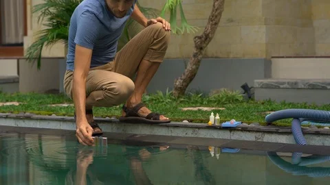 Young man swimming pool serviceman checking chlorine, PH and other chemical Stock Footage 110897961
