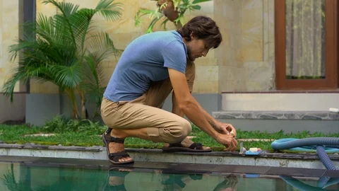 Young man swimming pool serviceman checking chlorine, PH and other chemical Stock Footage 110952473
