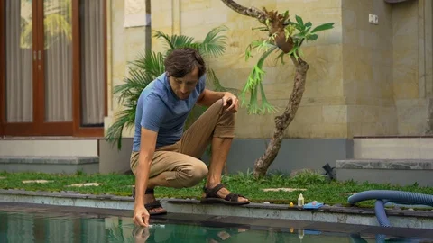 Young man swimming pool serviceman checking chlorine, PH and other chemical Stock Footage 110958246