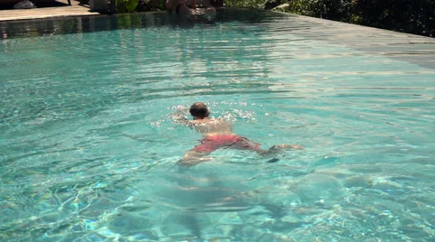 Young man swimming in pool, super slow motion 240fps 스톡 동영상 67754714