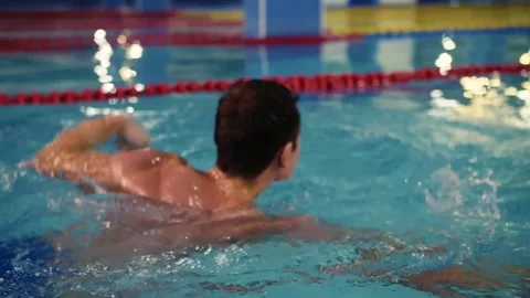 Young man swimming in the pool.Guy learning to swim in the pool.Sports and Stock Footage 208632870